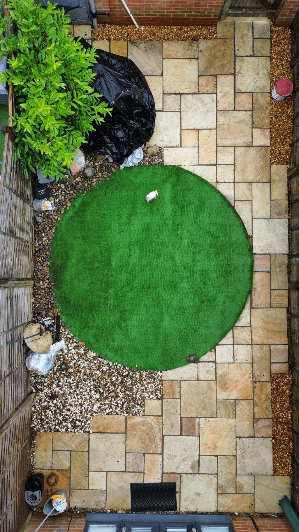 Aerial small courtyard patio with circular lawn after cleaning