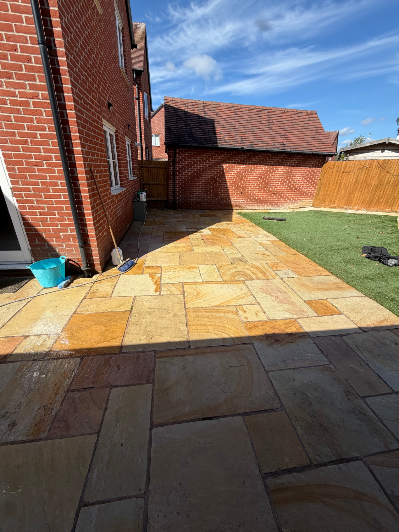 Overgrown sandstone patio after cleaning